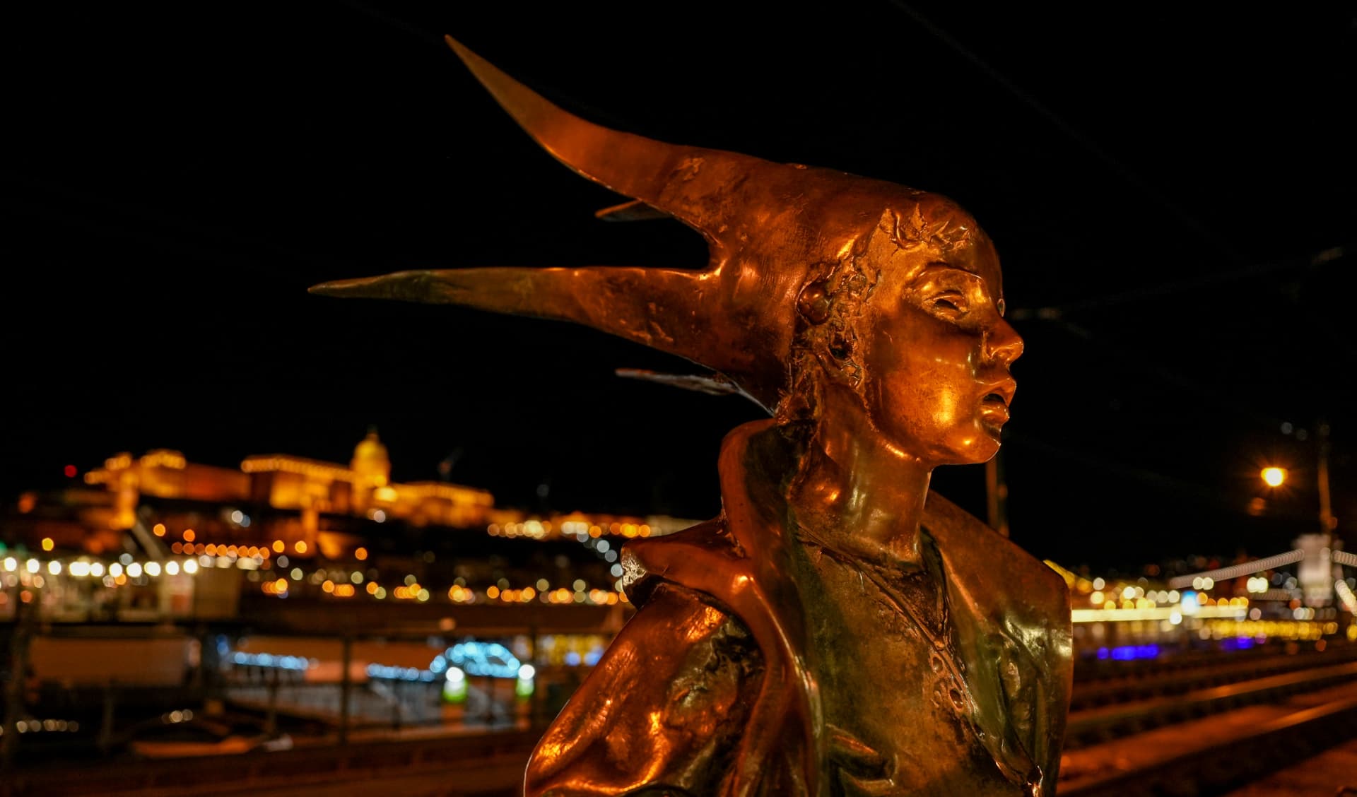 Golden statue on the Danube at night